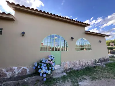 a house with flowers on the side of it at La Maguada in Tanti