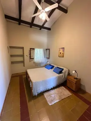 a bedroom with a bed and a ceiling fan at La Maguada in Tanti