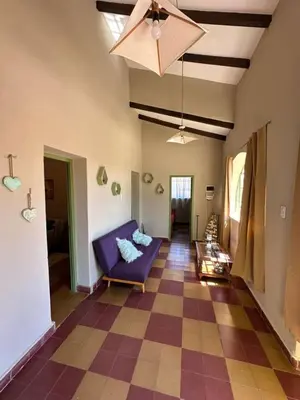 a living room with a purple couch on a checkered floor at La Maguada in Tanti