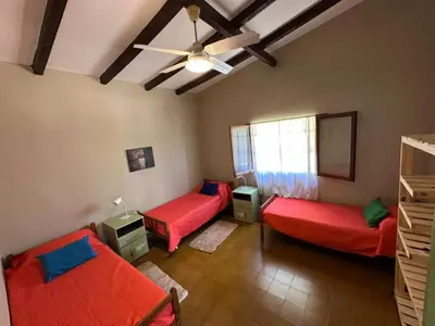 a room with two beds and a ceiling fan at La Maguada in Tanti