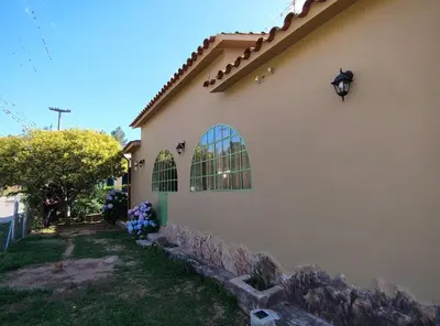 a side view of a house with a stone wall at La Maguada in Tanti