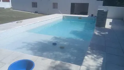 a swimming pool with two balls in the water at La Gringa in Tanti
