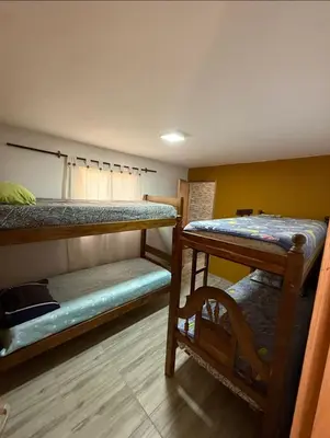 a room with two bunk beds and a table at La Gringa in Tanti