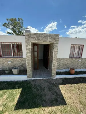 a brick building with a door in a yard at La Gringa in Tanti