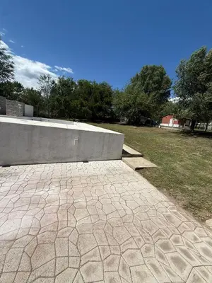 a stone walkway in a park with a wall at La Gringa in Tanti