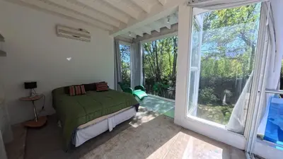 a bedroom with a bed and a large window at Zeus in Las Chacras (La Paz)