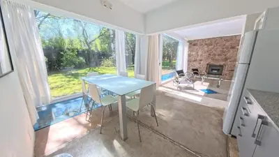 a table and chairs in a kitchen with a large window at Zeus in Las Chacras (La Paz)