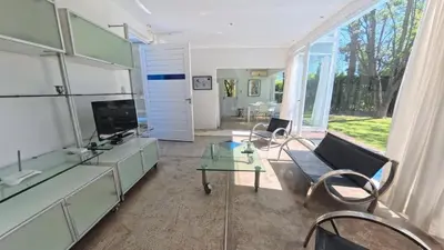 a living room with a couch and a glass table at Zeus in Las Chacras (La Paz)