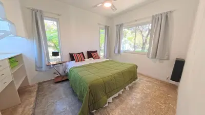 a bedroom with a bed and two windows at Zeus in Las Chacras (La Paz)