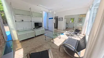 a living room with a glass table and chairs at Zeus in Las Chacras (La Paz)