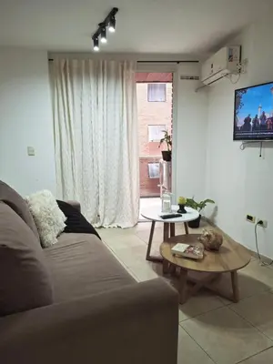 a living room with a couch and a table at Departamento en Nueva Cordobá, CORDOBA in Cordoba