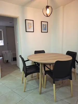 a dining room table with black chairs and a light fixture at Departamento en Nueva Cordobá, CORDOBA in Cordoba