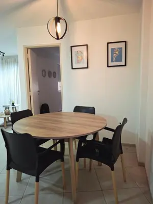 a dining room with a wooden table and chairs at Departamento en Nueva Cordobá, CORDOBA in Cordoba