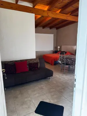 a living room with a couch and a table at Santa Rita Loft in Villa Carlos Paz