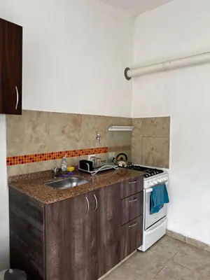 a kitchen with a sink and a stove at Santa Rita Loft in Villa Carlos Paz