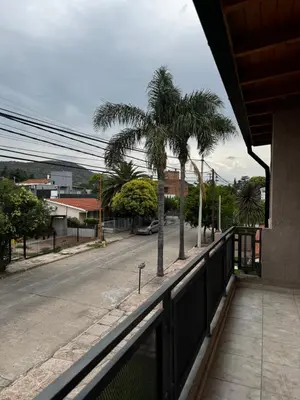 a balcony with a view of a street with palm trees at Santa Rita Loft in Villa Carlos Paz