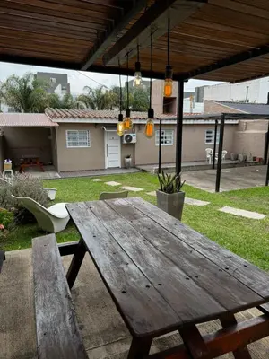 a wooden picnic table in the backyard of a house at Santa Rita Loft in Villa Carlos Paz