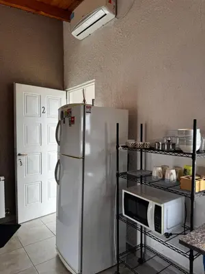 a kitchen with a white refrigerator and a microwave at Santa Rita Loft in Villa Carlos Paz