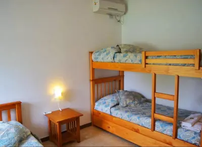 a room with two bunk beds and a table at Rumipaz in Villa Rumipal