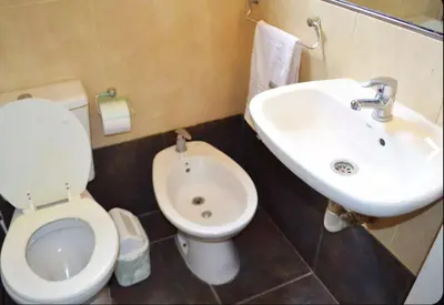 a bathroom with a toilet and a sink at Rumipaz in Villa Rumipal