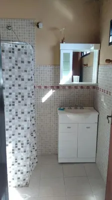 a bathroom with a white sink and a mirror at Inambú in Villa Cura Brochero
