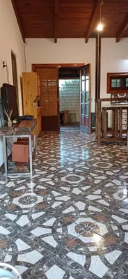a large room with a tile floor with a table at Cabaña Benitto in Potrero de Garay
