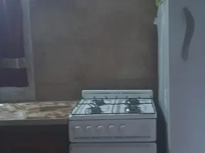 a stove top oven sitting in a kitchen at Departamentos Mis 5 Soles in Villa Cura Brochero