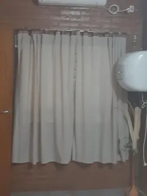a window with a white curtain in a bathroom at Departamentos Mis 5 Soles in Villa Cura Brochero