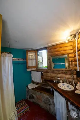a bathroom with a sink and a mirror at Intihuasi Casa del Sol in Atos Pampa