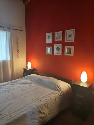 a bedroom with a bed with two lamps on it at Casa en Cabalango in Cavalango
