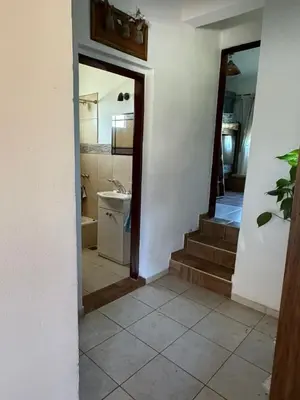 a hallway with a bathroom with a sink and a staircase at Casa en Cabalango in Cavalango