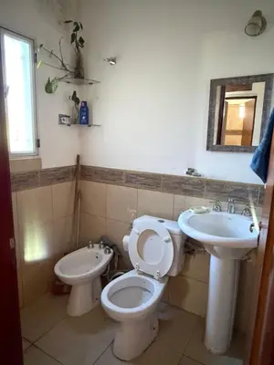 a bathroom with a toilet and a sink at Casa en Cabalango in Cavalango