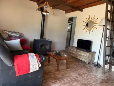 a living room with a couch and a wood stove at Casa en Cabalango in Cavalango