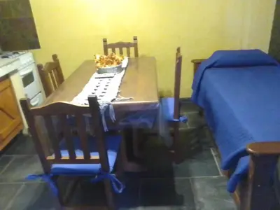 a dining room table and chairs with a keyboard on it at Cabañas Ojo de Agua in Trapiche