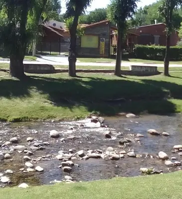 a group of rocks in a stream in a park at Cabañas Ojo de Agua in Trapiche