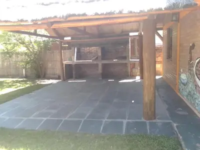 a large patio with a wooden pergola at Cabañas Ojo de Agua in Trapiche