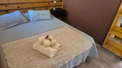 a bedroom with a bed with towels on it at La Insolente in Villa Yacanto