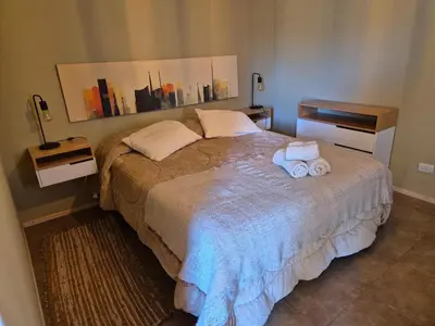 a bedroom with a bed with two towels on it at La Insolente in Villa Yacanto