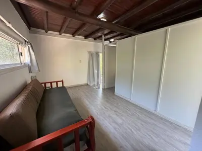 a living room with a couch and a window at Gea in Las Chacras (La Paz)