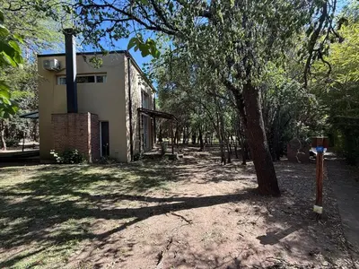 a house with a tree next to a building at Gea in Las Chacras (La Paz)