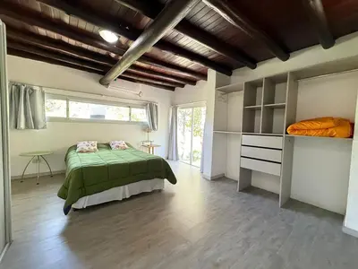 a bedroom with a bed and a large window at Gea in Las Chacras (La Paz)