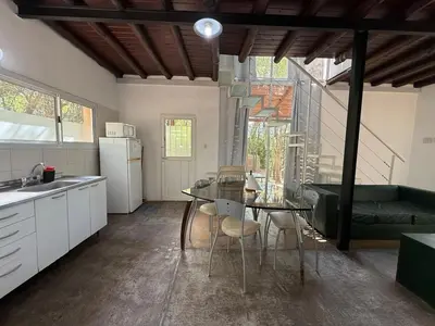 a kitchen with a table and chairs in a room at Gea in Las Chacras (La Paz)