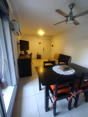 a room with a table and a living room with a ceiling fan at Confort en Barrio General Paz in Cordoba