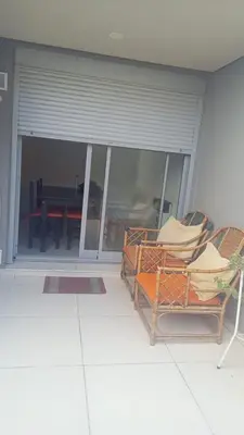 a room with two chairs and a patio with a table at Confort en Barrio General Paz in Cordoba