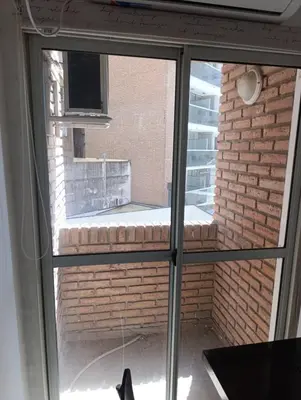 a window with a view of a brick building at departamento amoblado en Nueva cba-a metros de la terminal omnibus in Cordoba