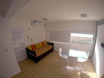 a small living room with a couch and a table at Complejo de Cabañas Coquena in San Antonio de Arredondo