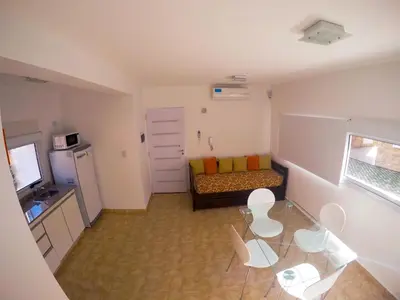 a small living room with a table and a couch at Complejo de Cabañas Coquena in San Antonio de Arredondo