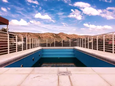 a swimming pool on the roof of a house at Complejo de Cabañas Coquena in San Antonio de Arredondo