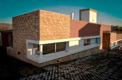 a rendering of a building with a brick wall at Complejo de Cabañas Coquena in San Antonio de Arredondo