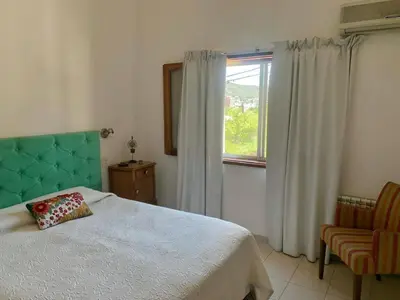 a bedroom with a bed and a window at Casa Maru in Villa Carlos Paz